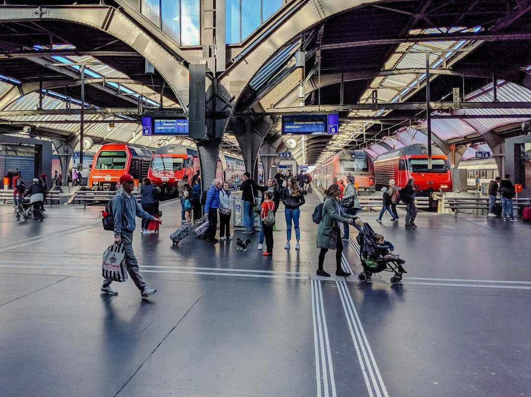 Interior view of a busy Swiss train station