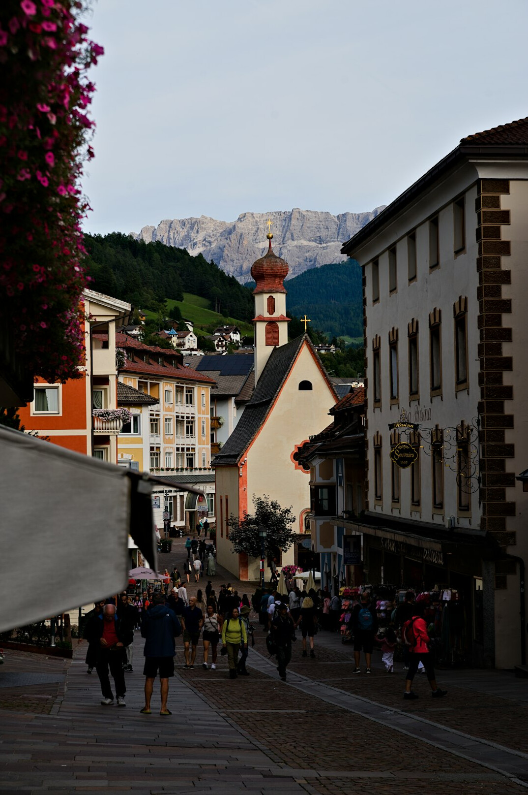 Tourists walking through a crowded alpine village street